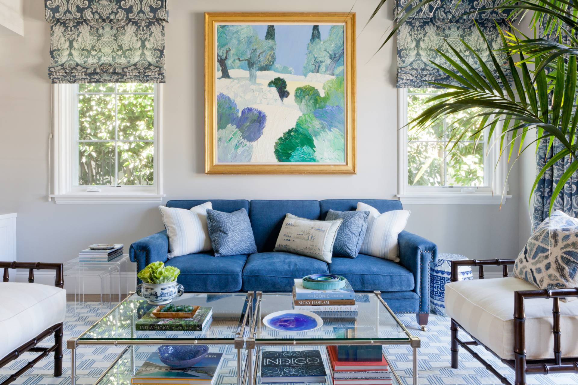 Blue velvet sofa with blue fleur de lis roman shades